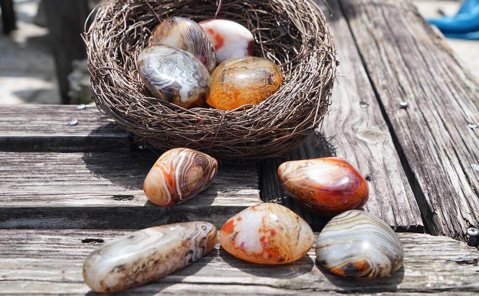 Some agate stones on the table and in a basket